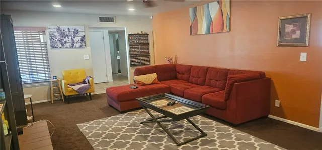 a living room with furniture and a rug