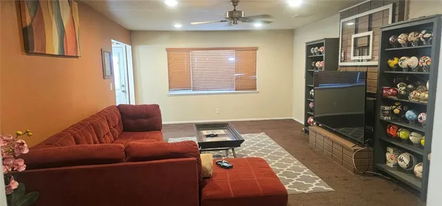 a living room with furniture cabinets and a window
