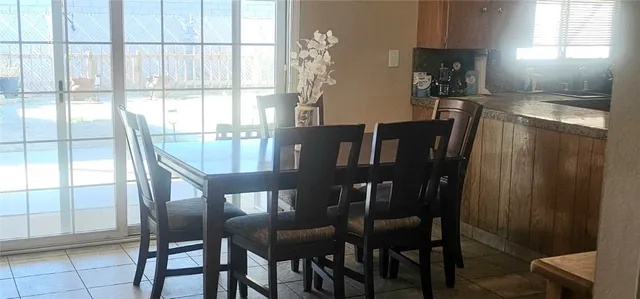 a view of a dining room with furniture and window