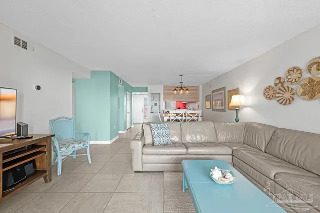 a large bed sitting in a bedroom next to a window