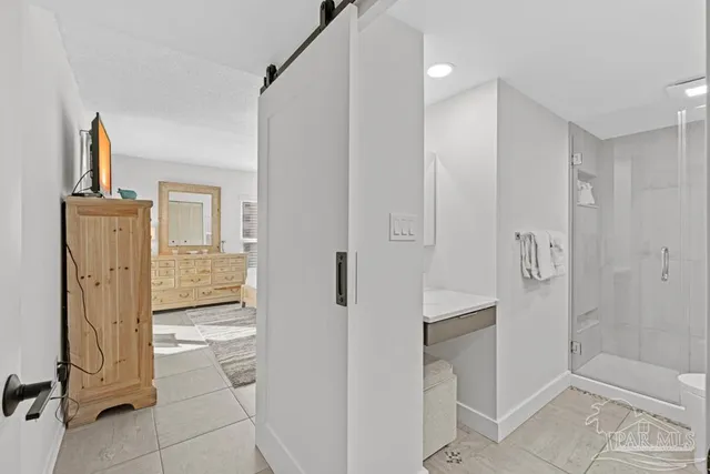 a bedroom with a bed and a night stand