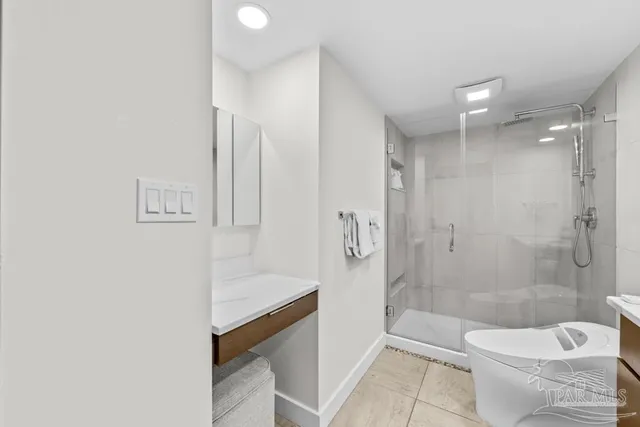 a bedroom with a bed a couch and painting on the wall