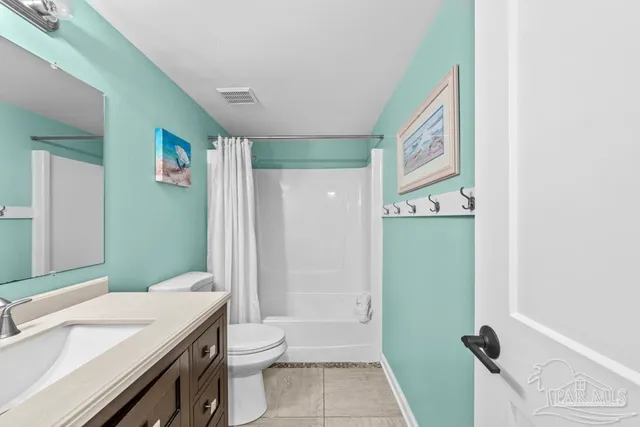 a spacious bedroom with a bed and a couch