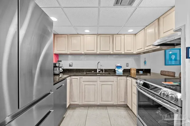 a kitchen with stainless steel appliances granite countertop a stove and a sink