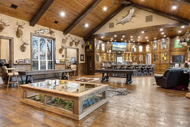 a living room with lots of furniture and kitchen view