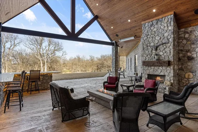 a living room with fireplace furniture and a large window