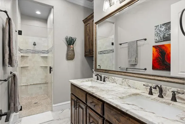 a bathroom with a granite countertop sink mirror and double