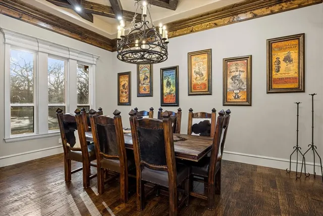 a view of a dining room with furniture a chandelier and wooden floor
