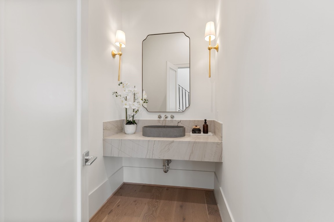 1407 Martin Street Houston, TX 77018 - Photo 14 of 44 A sleek powder bath offers a refined design with a floating quartzite vanity, modern fixtures, and elevated finishes that reflect the home’s attention to detail.