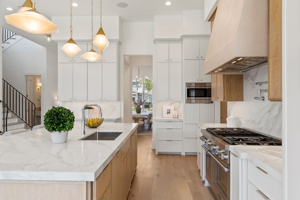1407 Martin Street Houston, TX 77018 - Photo 19 of 44 a kitchen with stainless steel appliances kitchen island granite countertop a stove a sink and a white cabinets