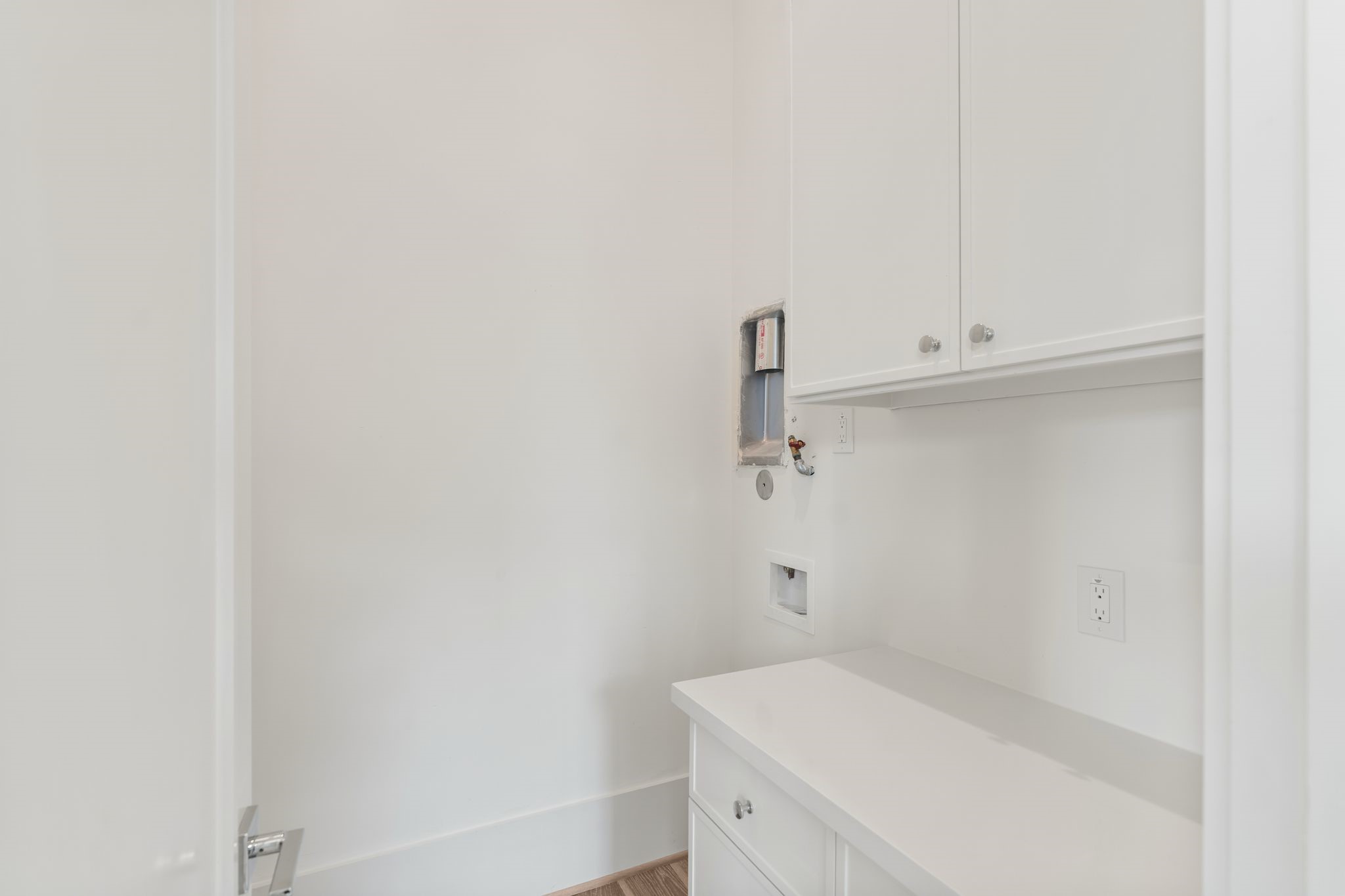 1407 Martin Street Houston, TX 77018 - Photo 21 of 44 A well-appointed laundry room offers built-in cabinetry, ample counter space, and designated connections for full-size appliances, designed for everyday convenience.