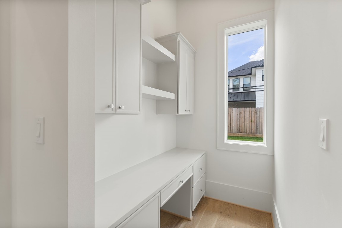 1407 Martin Street Houston, TX 77018 - Photo 22 of 44 Additional built-in storage and workspace create a functional drop zone, ideal for organization while maintaining the home’s clean and polished look.