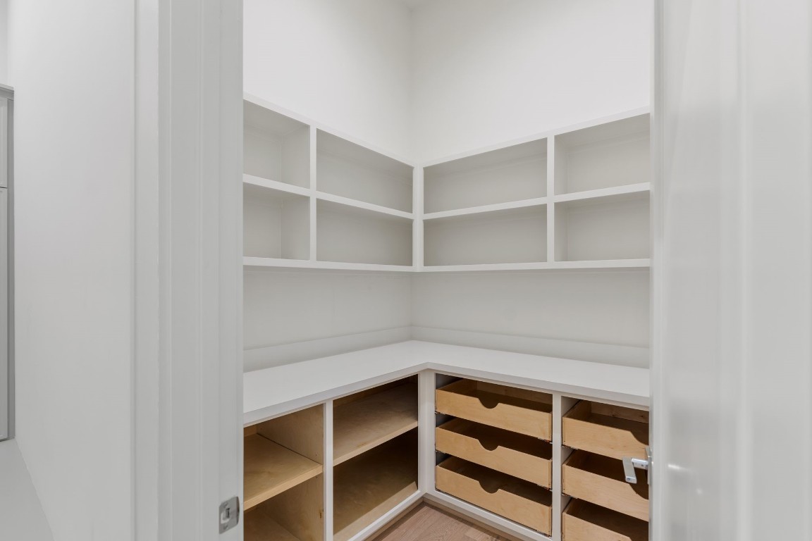 1407 Martin Street Houston, TX 77018 - Photo 26 of 44 A custom walk-in pantry is designed with built-in cabinetry, drawers, and shelving, providing both organization and a tailored, high-end feel.