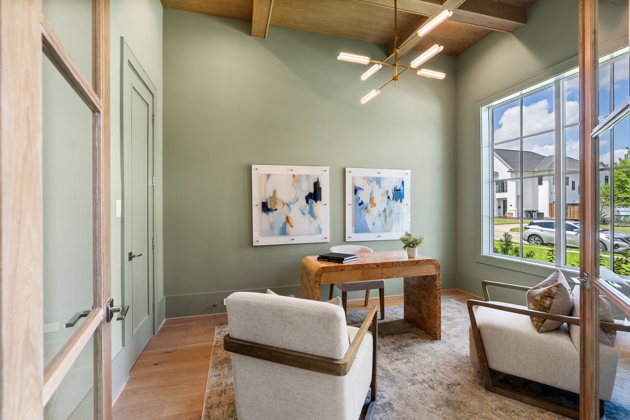 1407 Martin Street Houston, TX 77018 - Photo 3 of 44 Just off the entry, a private home office is framed by custom white oak doors and elevated by soaring ceilings. Natural light pours in through large windows, highlighting the refined finishes and craftsmanship.