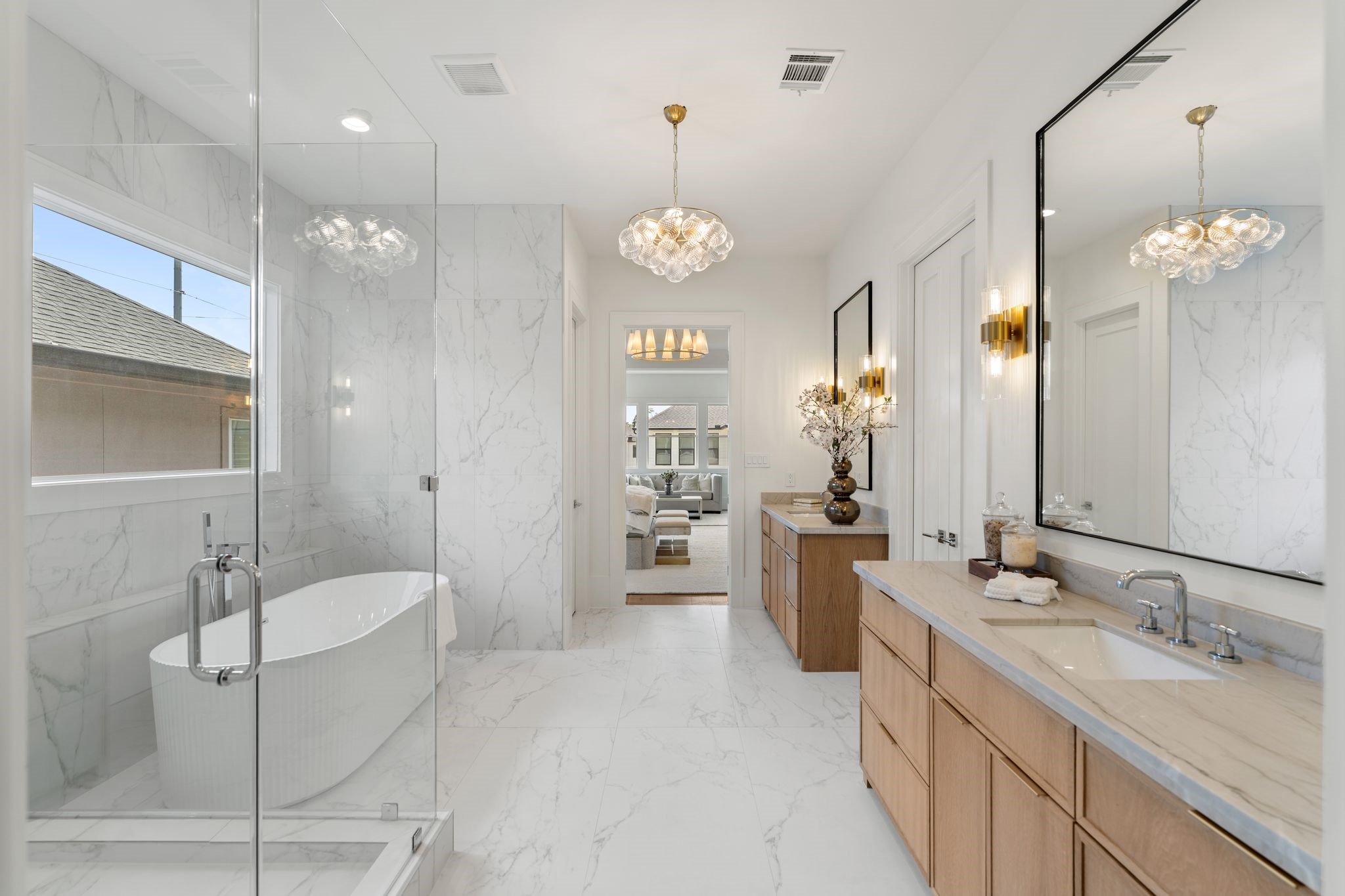 1407 Martin Street Houston, TX 77018 - Photo 33 of 44 The spa-inspired primary bath features dual vanities with custom cabinetry, quartz countertops, and designer lighting, creating a refined and functional space.