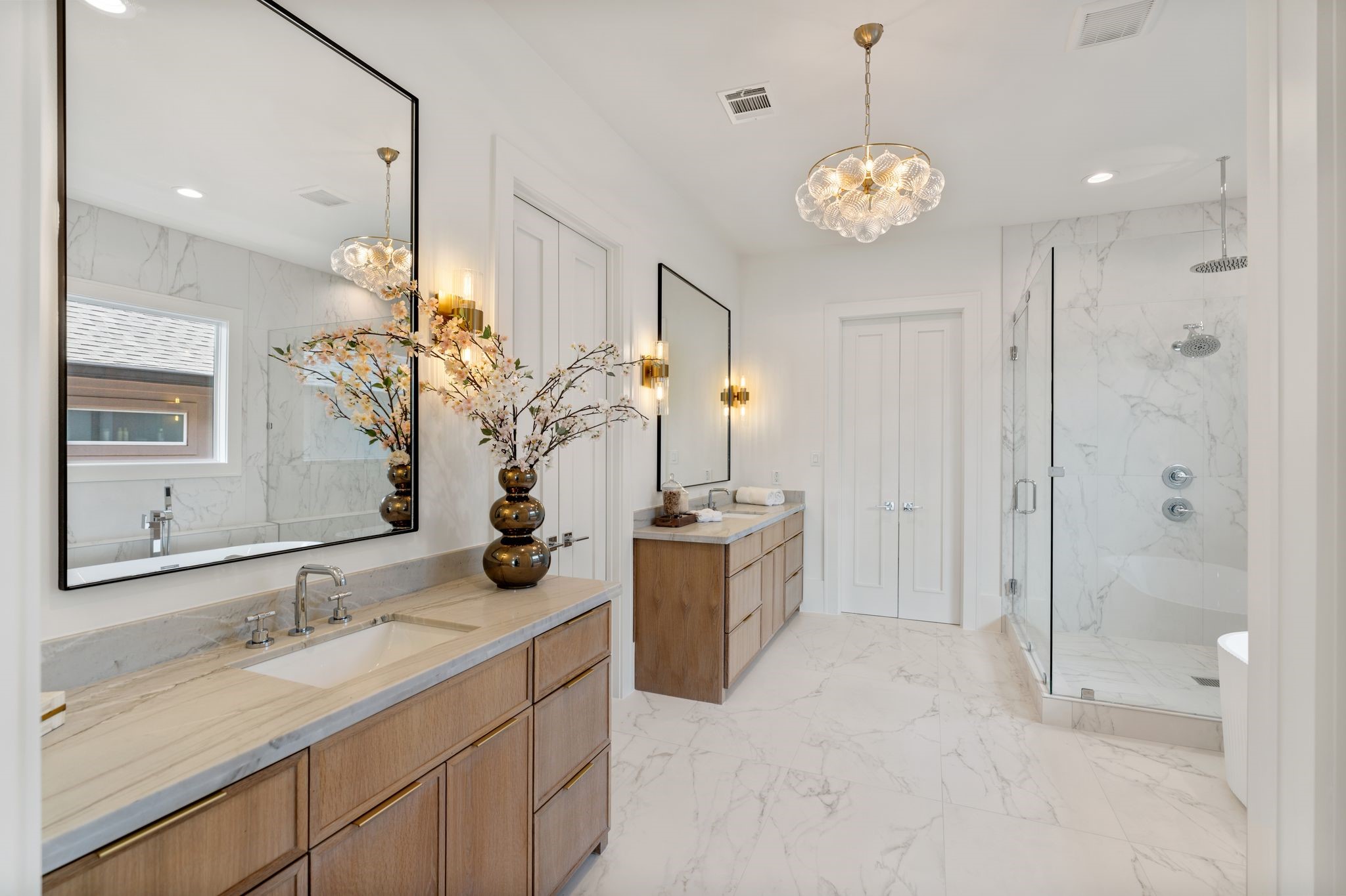 1407 Martin Street Houston, TX 77018 - Photo 34 of 44 The spa-inspired primary bath features dual vanities with custom cabinetry, quartz countertops, and designer lighting, creating a refined and functional space.