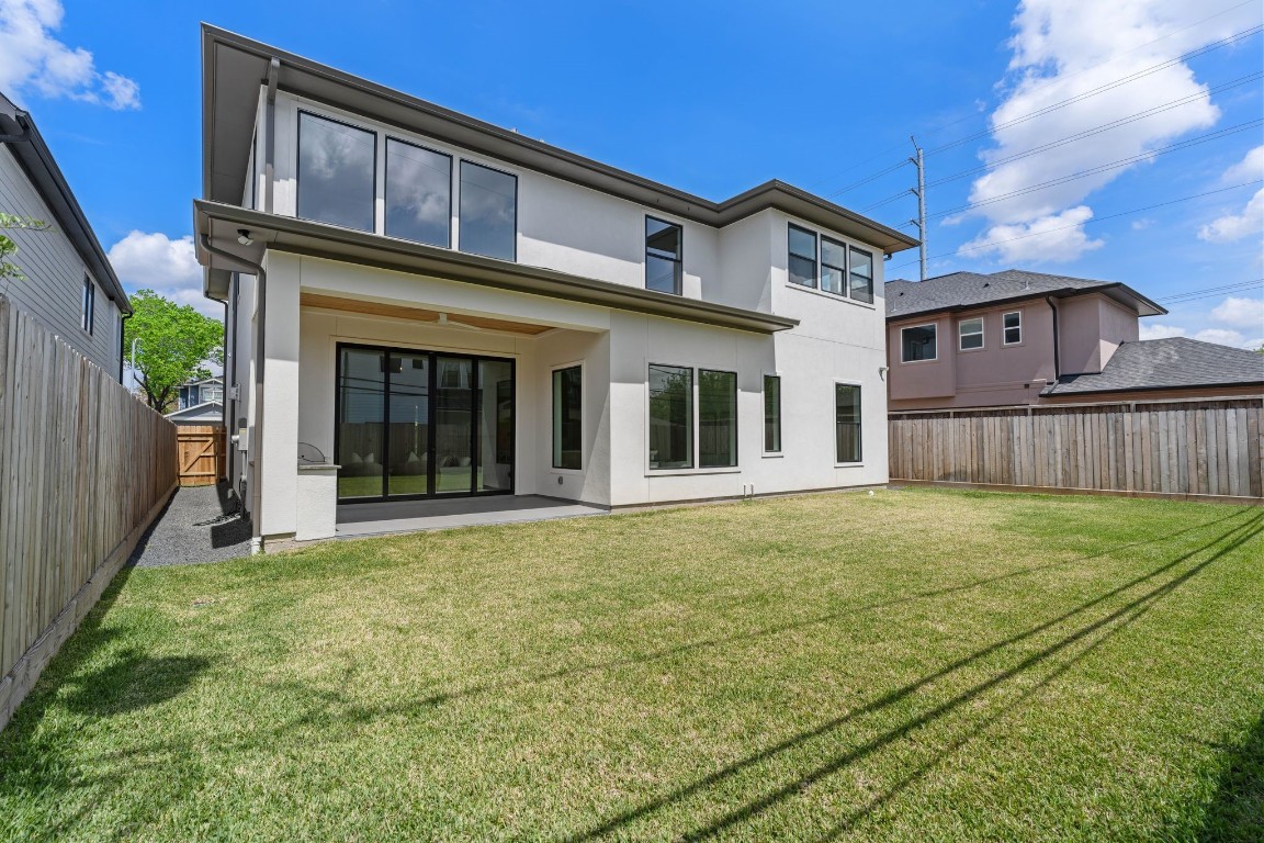 1407 Martin Street Houston, TX 77018 - Photo 43 of 44 A spacious, fully fenced backyard offers plenty of room for entertaining, play, or future pool plans, with clean landscaping and open green space.
