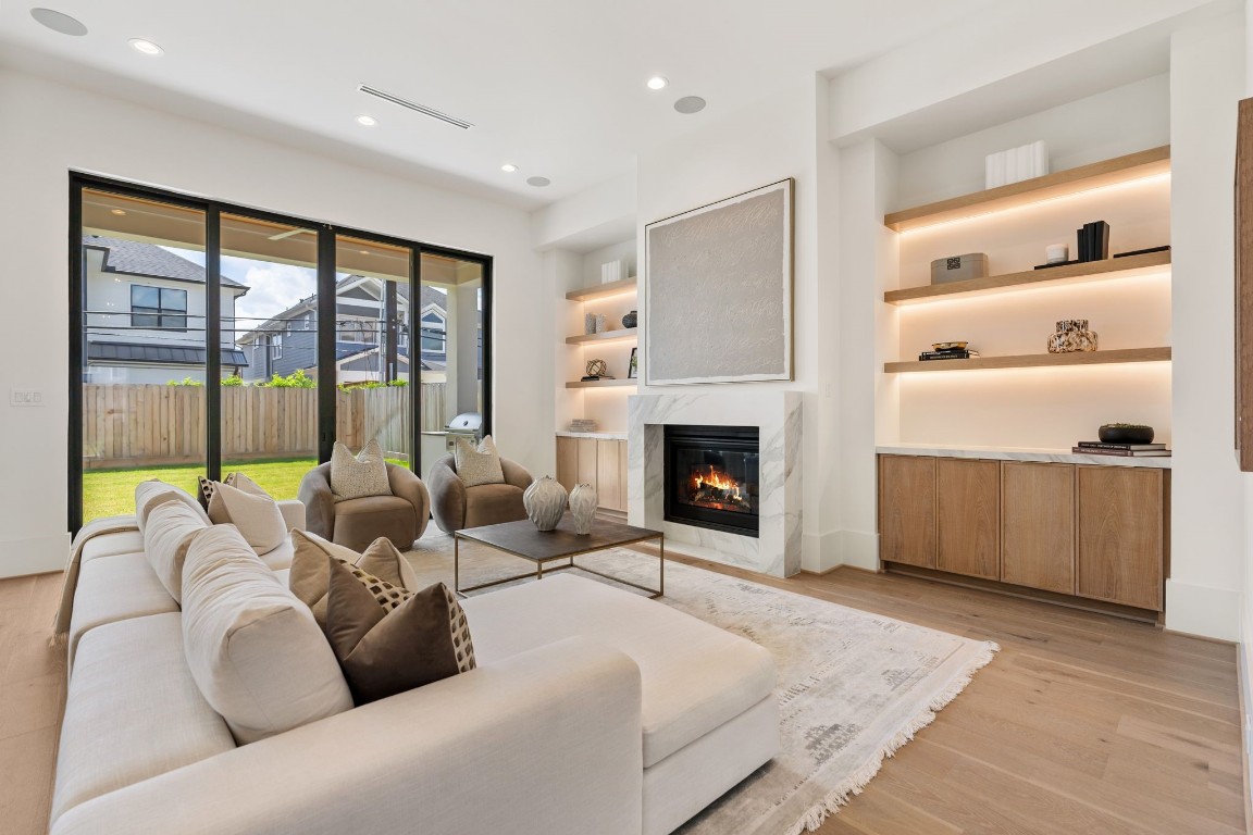 1407 Martin Street Houston, TX 77018 - Photo 5 of 44 The living room opens beautifully to the outdoors through oversized sliding doors, filling the space with natural light and creating a seamless indoor-outdoor connection to the covered patio and backyard.
