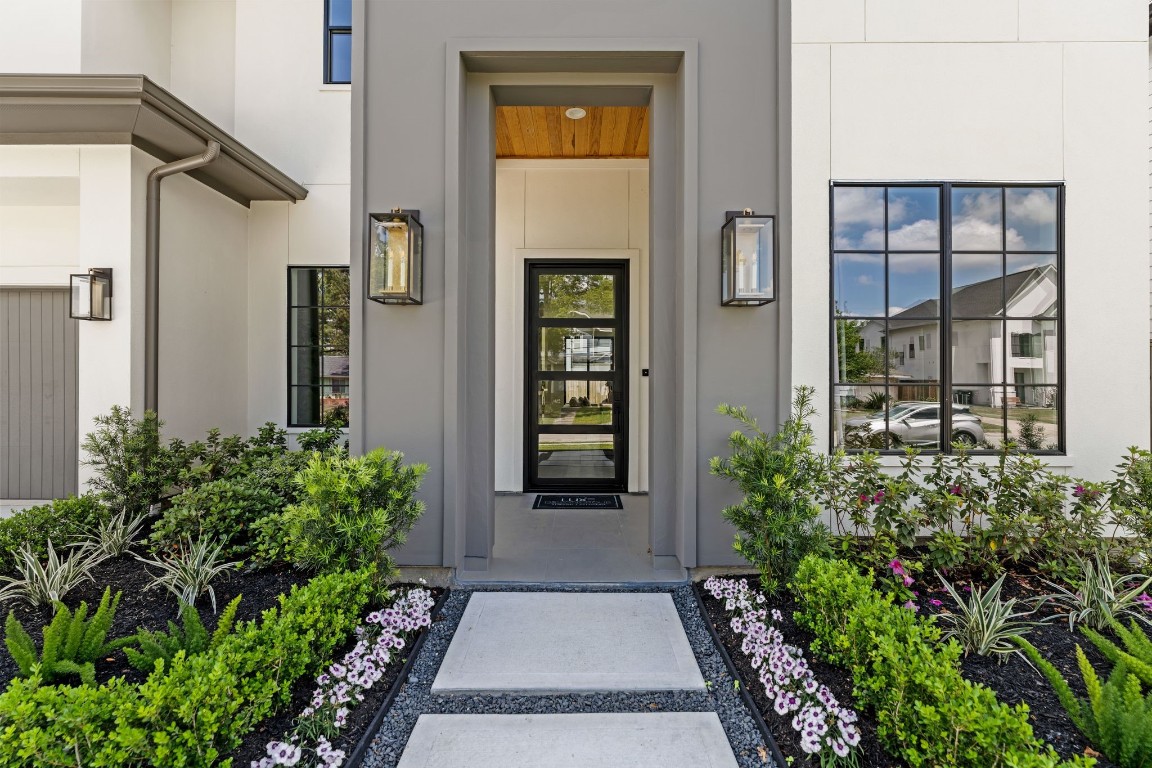 1407 Martin Street Houston, TX 77018 - Photo 7 of 44 Dark stucco accents,lush landscaping, an oversized steel front door and warm wood tones greet you before you even step inside.