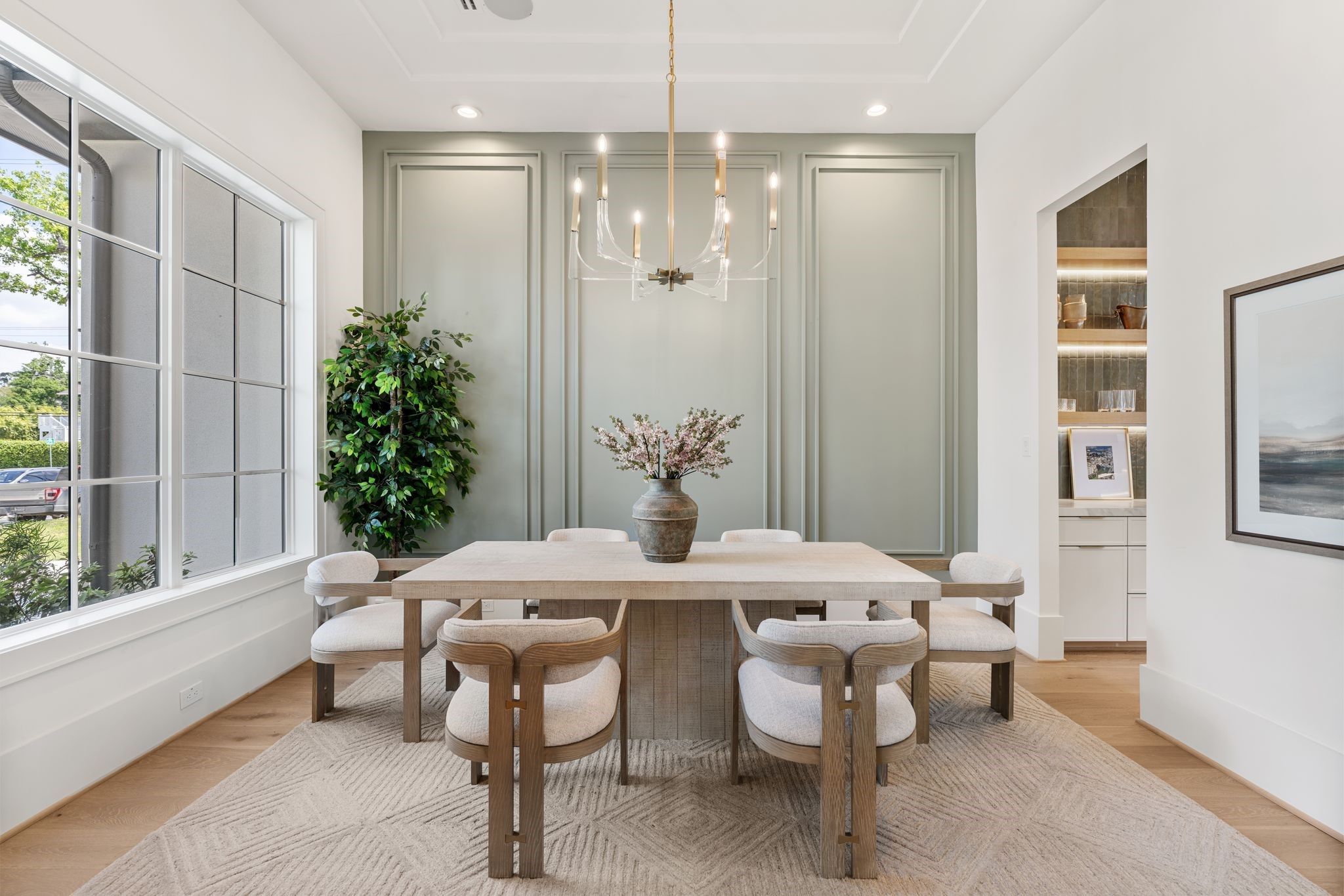 1407 Martin Street Houston, TX 77018 - Photo 8 of 44 The dining room is anchored by expansive windows that fill the space with natural light, enhancing the scale and architectural detailing while maintaining a bright, airy feel.