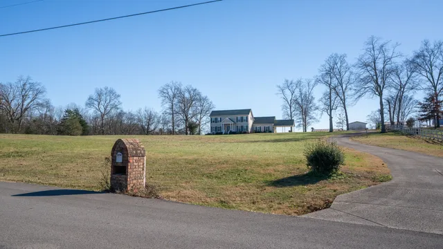 a view of a livingroom with wooden floor and a fireplace