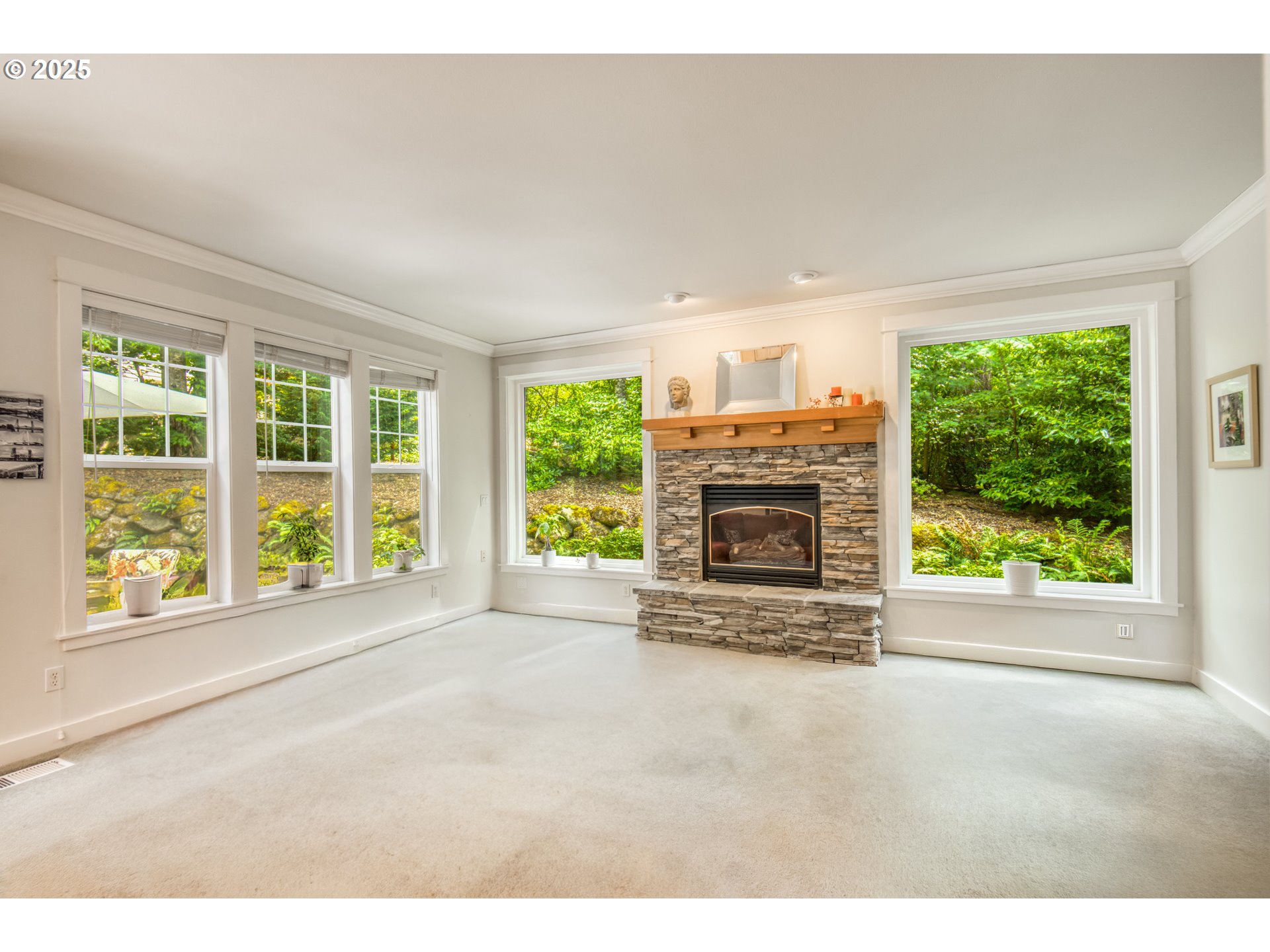 11540 Southwest 58th Court Portland, OR 97219 - Photo 12 of 33 a view of an empty room with a fireplace and a window