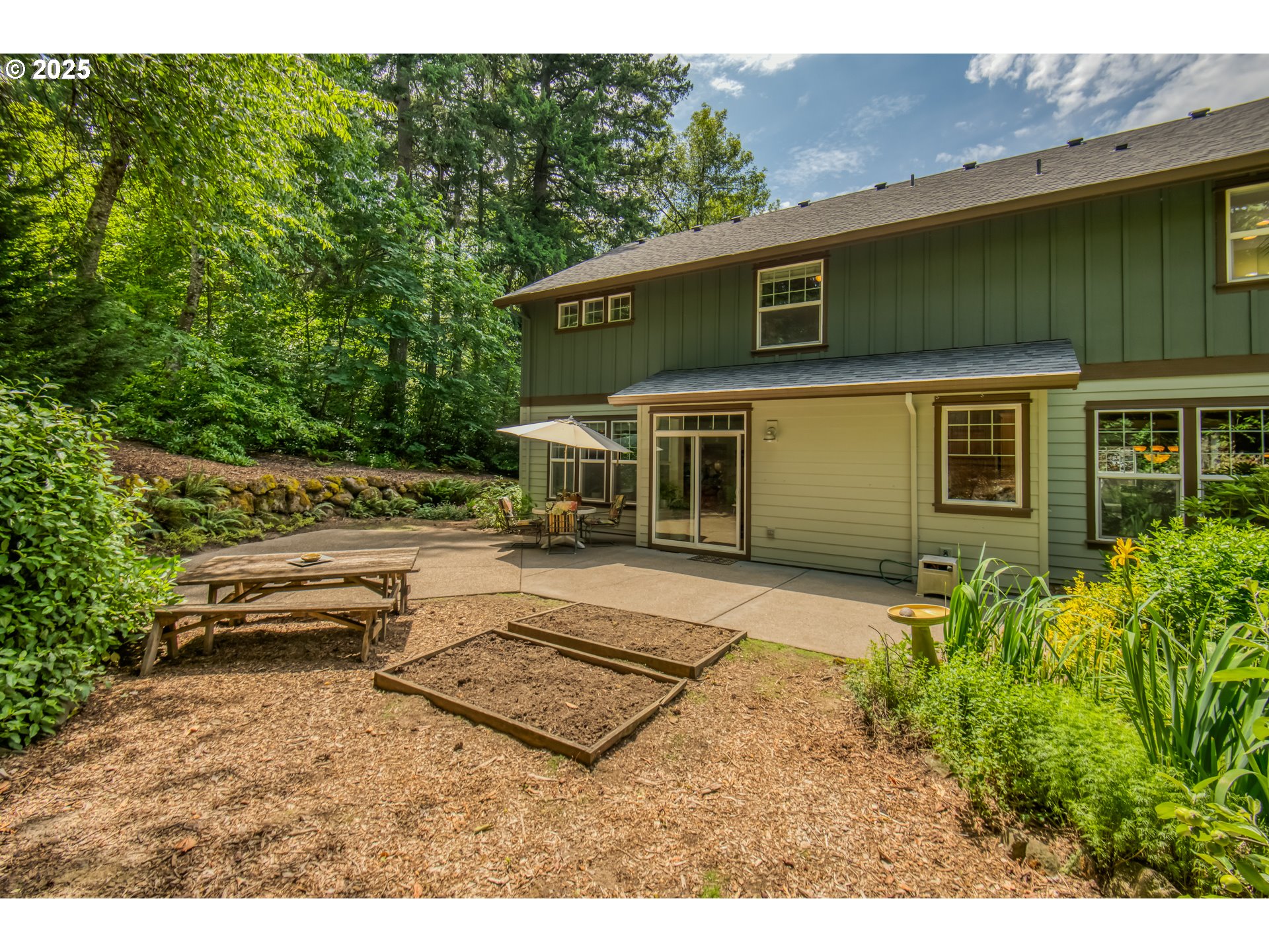11540 Southwest 58th Court Portland, OR 97219 - Photo 29 of 33 a backyard of a house with a garden and barbeque oven