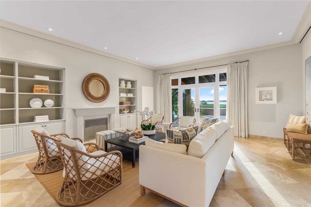 2350 Quay Dock Road Vero Beach, FL 32967 - Photo 13 of 35 a living room with furniture a clock and a large window