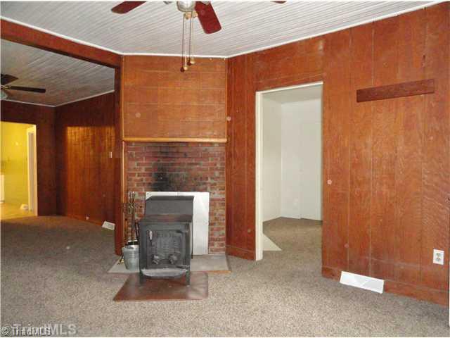 3360 Valley Road Winston-Salem, NC 27106 - Photo 2 of 15 Living Room. A charming wood stove keeps you warm without using the furnace.