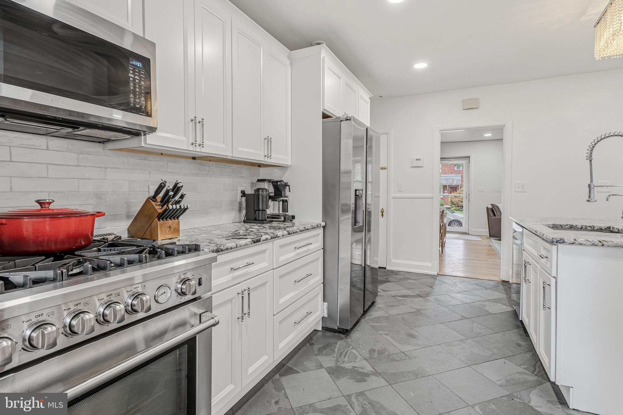 314 Murdock Road Baltimore, MD 21212 - Photo 11 of 42 a kitchen with stainless steel appliances granite countertop a stove a sink and a microwave