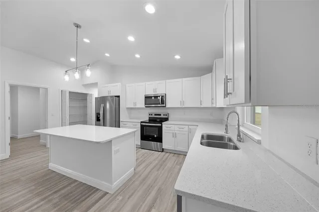a large kitchen with stainless steel appliances