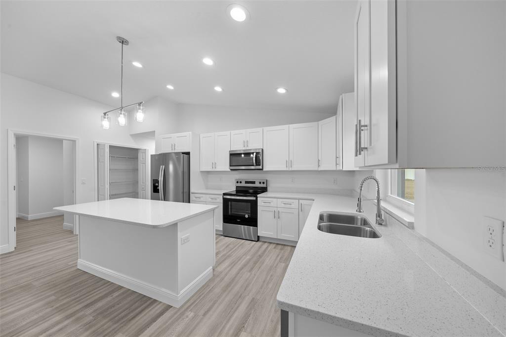 7 Walnut Place Ocala, FL 34480 - Photo 11 of 39 a large kitchen with stainless steel appliances