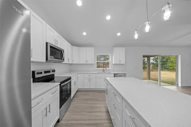 a large kitchen with a stove top oven