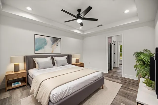 a bedroom with a bed and a potted plant