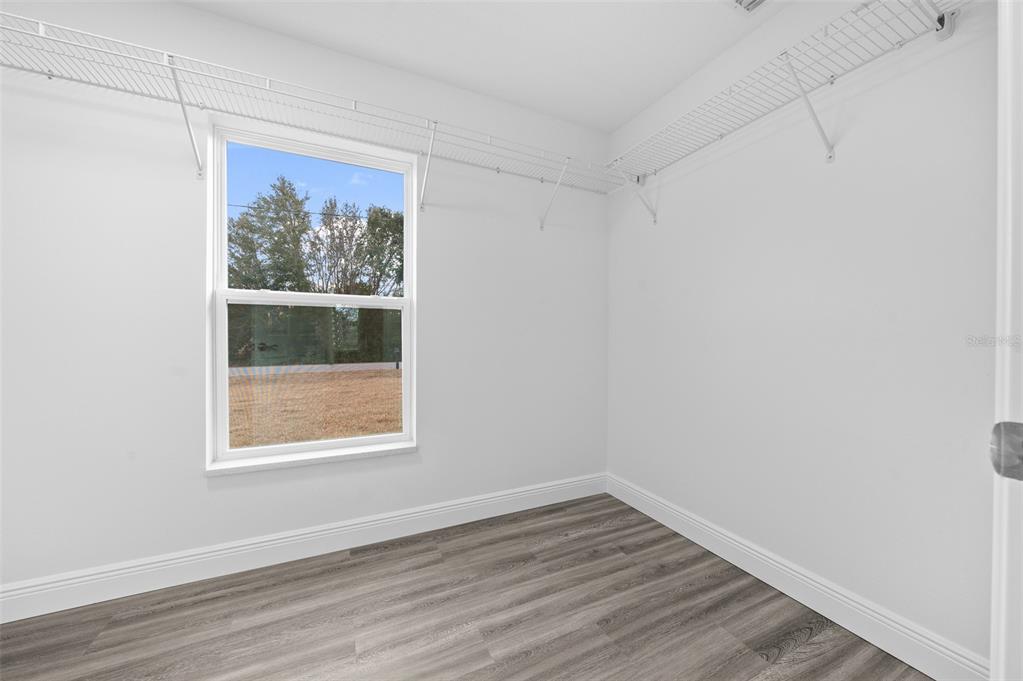 7 Walnut Place Ocala, FL 34480 - Photo 24 of 39 a view of an empty room with wooden floor and a window