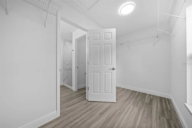 a view of a hallway with wooden floor