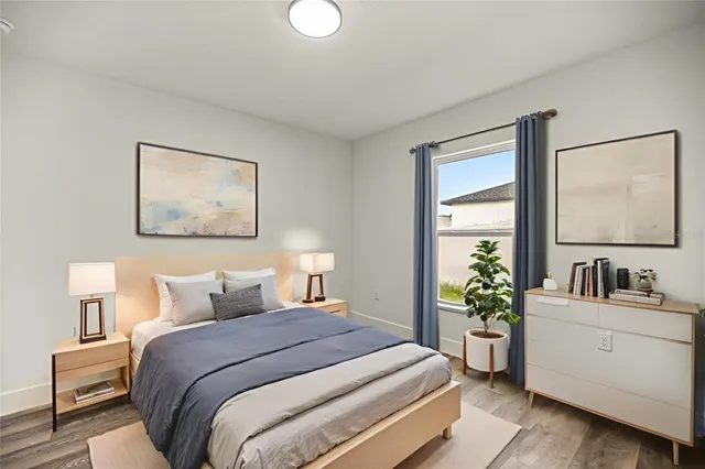 a bedroom with a bed and a potted plant