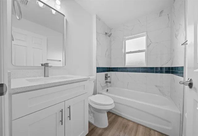 a bathroom with a sink a toilet and a bathtub