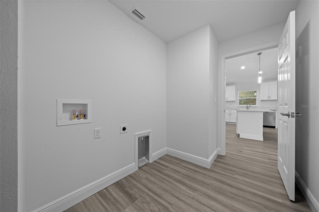 7 Walnut Place Ocala, FL 34480 - Photo 36 of 39 a view of a kitchen with wooden floor and a sink