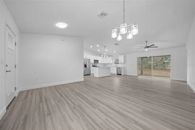 a view of a room with wooden floor and windows