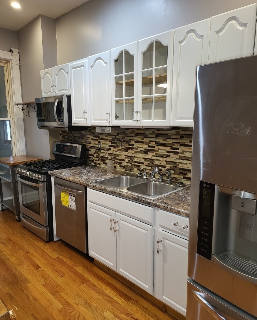 2663 West Maypole Avenue Chicago, IL 60612 - Photo 5 of 15 a kitchen with granite countertop a stove and a refrigerator