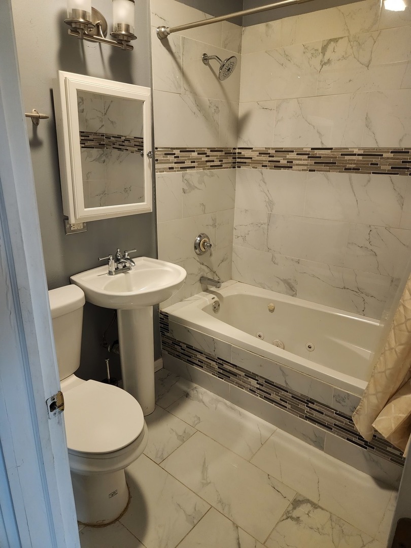 2663 West Maypole Avenue Chicago, IL 60612 - Photo 6 of 15 a bathroom with a sink and a mirror