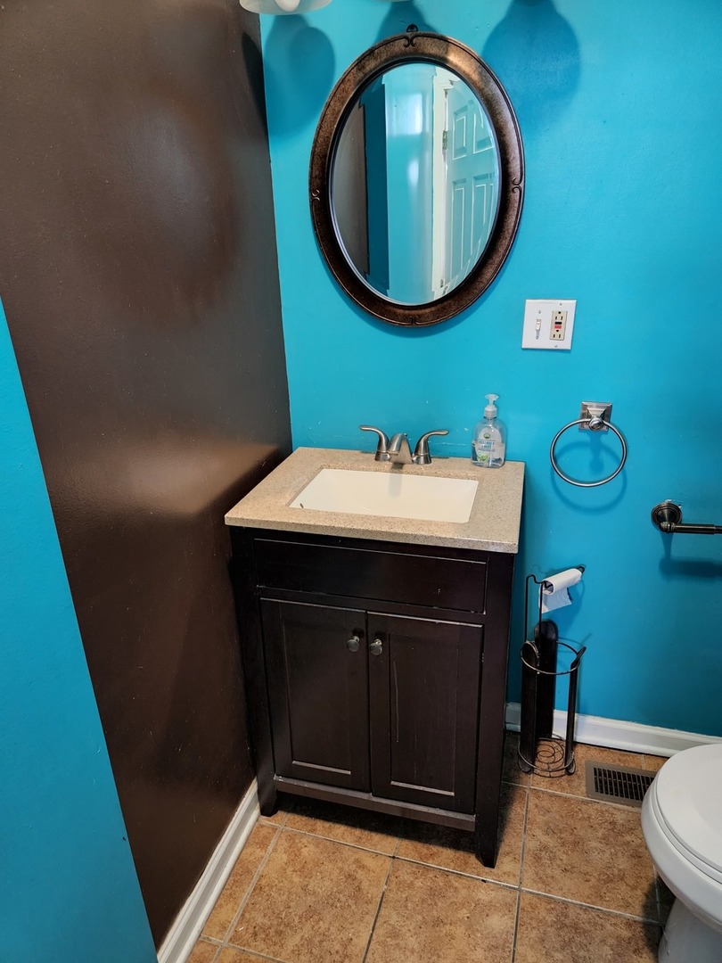 2663 West Maypole Avenue Chicago, IL 60612 - Photo 7 of 15 a bathroom with a sink and a mirror
