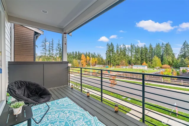 a view of a balcony with chairs and a potted plant
