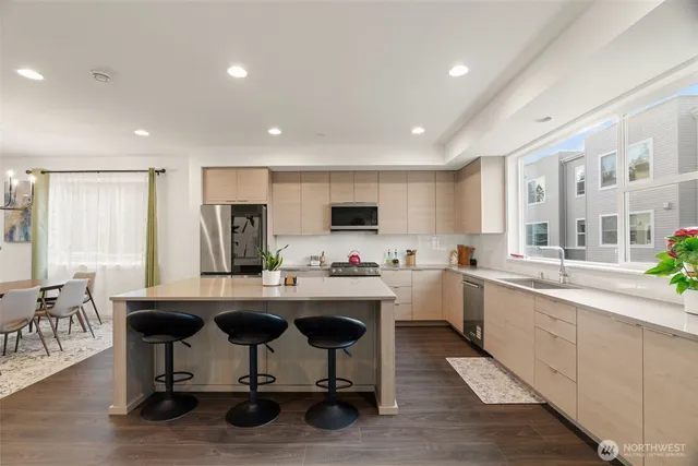 a kitchen with sink cabinets and dining table