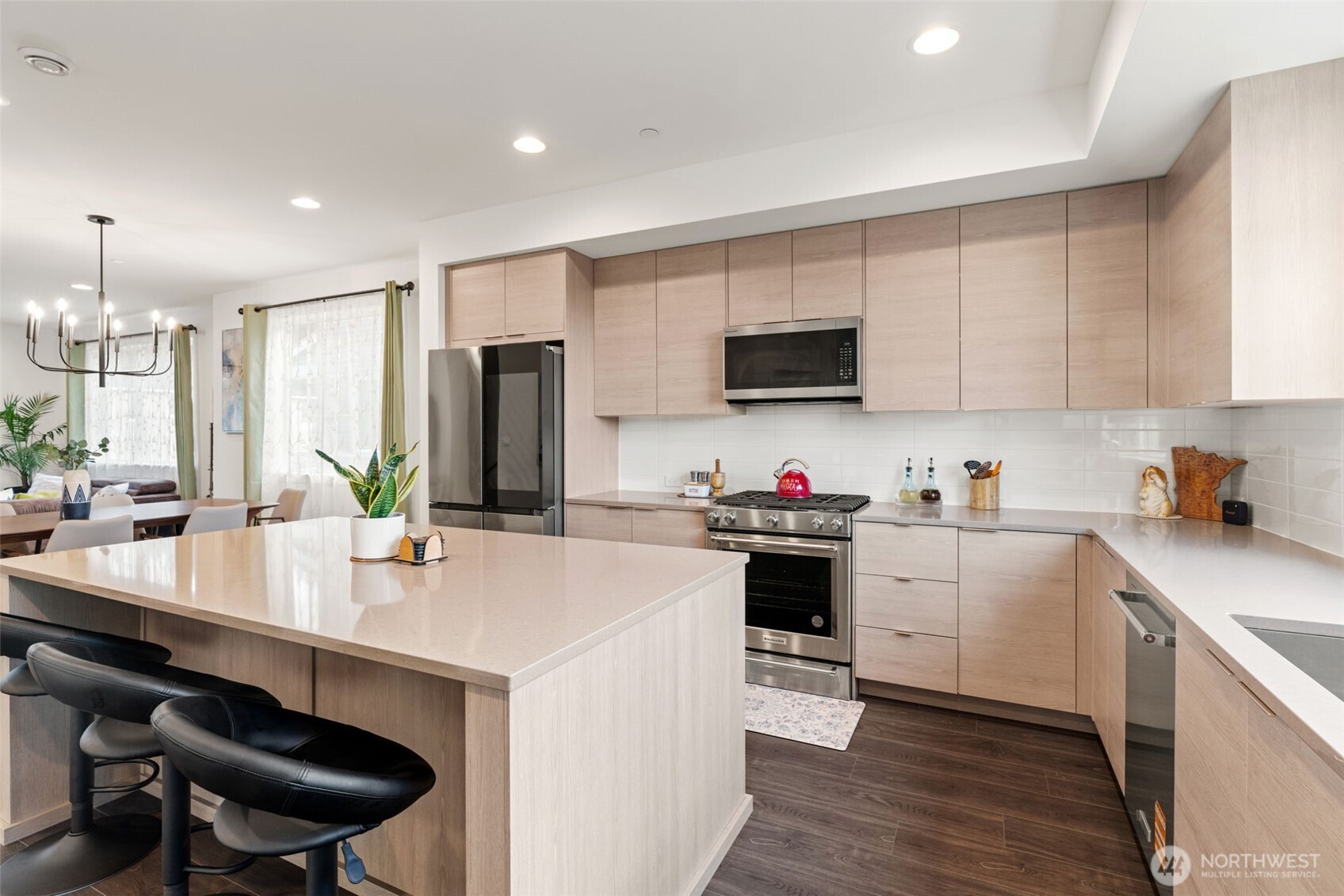 3915 198th Street Southeast, Unit F4 Bothell, WA 98012 - Photo 24 of 38 a kitchen with a sink a stove a refrigerator and chairs