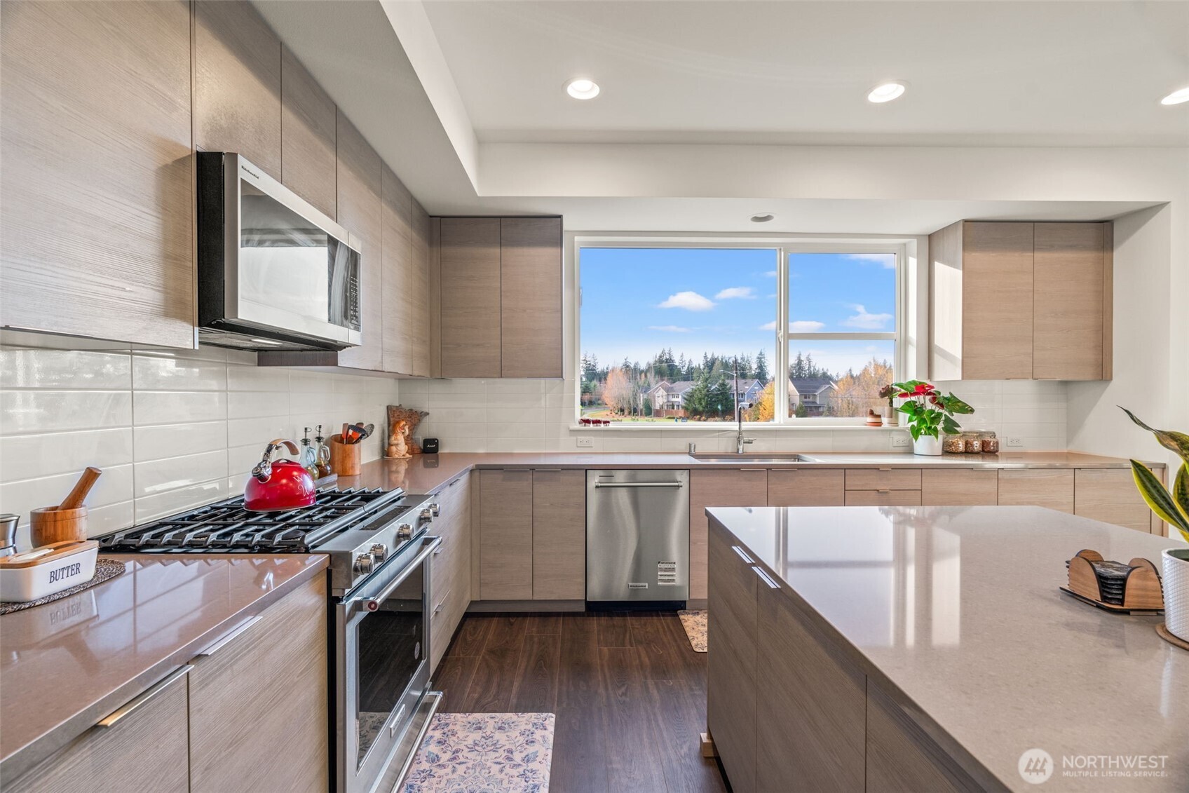 3915 198th Street Southeast, Unit F4 Bothell, WA 98012 - Photo 25 of 38 a kitchen with stainless steel appliances granite countertop a sink stove and cabinets