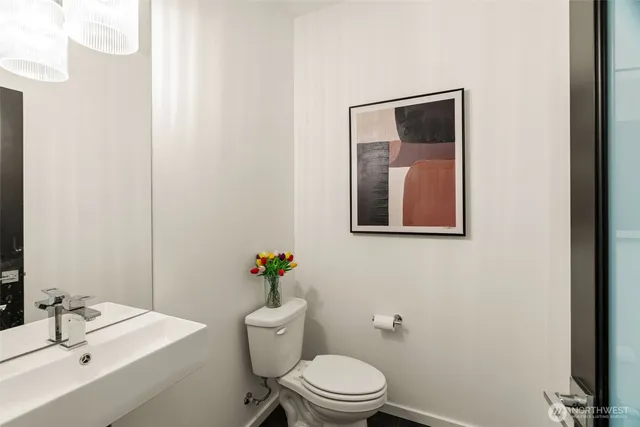 a white toilet sitting next to a bathroom sink