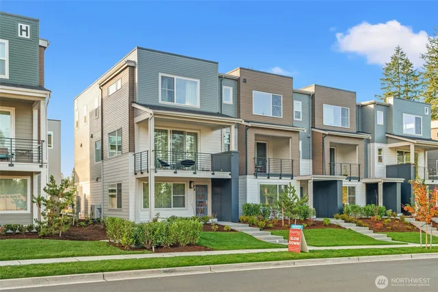 a front view of a residential apartment building with a yard