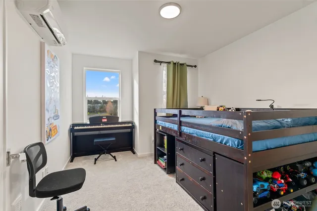 a bed room with a bed and a chair